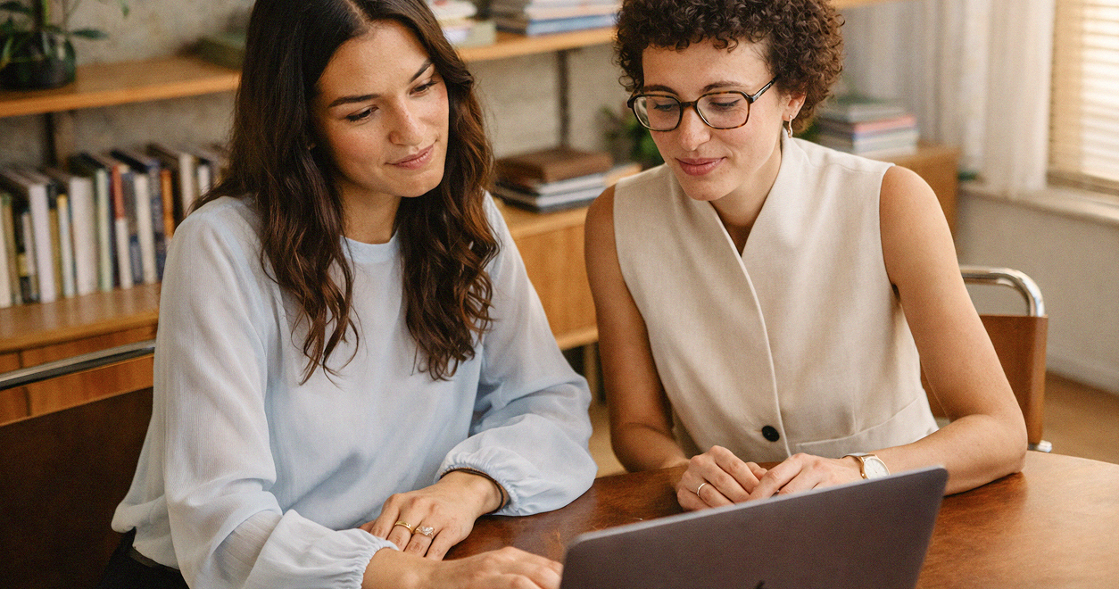 Two women chatting with laptop
